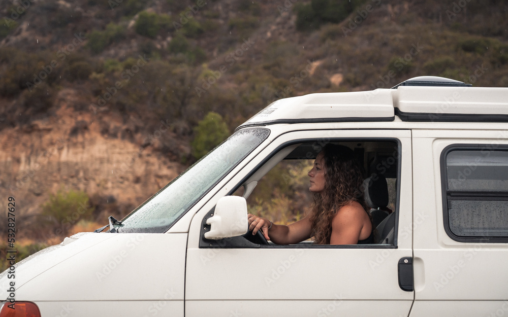 Woman Driving Vintage Van Near Hills