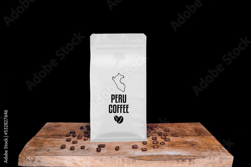 Peru coffee beans and white package on wooden board with black isolated background