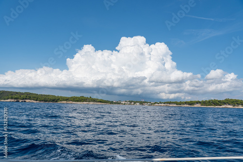 Kroatische Küstenlandschaft mit Meer im Vordergrund und Wolken am Himmel
