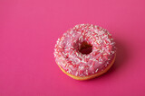 donut with pink icing and sprinkles, copy space, sweet pastry dessert