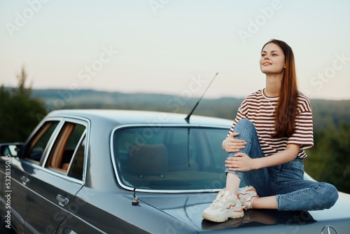 Woman sitting in her car on a road trip and relaxing, lifestyle on the road © SHOTPRIME STUDIO