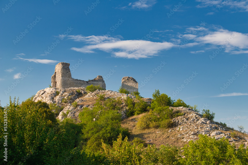 A ruin of castle Sirotci hradek in Moravia region, under white clouds. Palava,  Czech Republic.
