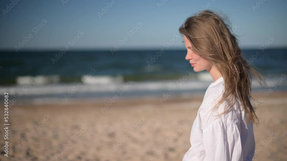 Romantic girl on sea background. Wind shakes long blond hair. Romantic girl on sea background. Wind shakes long blond hair.