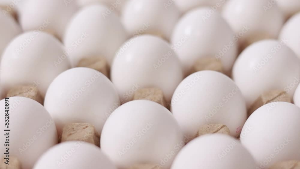 White chicken eggs in a cardboard box. Fresh raw eggs in a paper egg container for store and shop. egg tray with eggs on white table background. Top view. preparation to easter holiday. White chicken eggs in a cardboard box. Fresh raw eggs in a paper egg container for store and shop. egg tray with eggs on white table background. Top view. preparation to easter holiday.