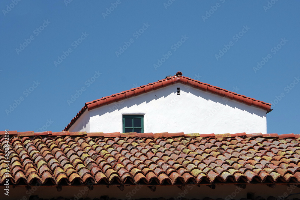 Partial view of an historic Mexican building with a tile roof Partial view of an historic Mexican building with a tile roof