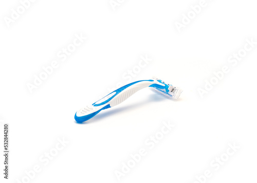 Single brand new blue and white plastic disposable razor with ergonomic handle isolated on white background