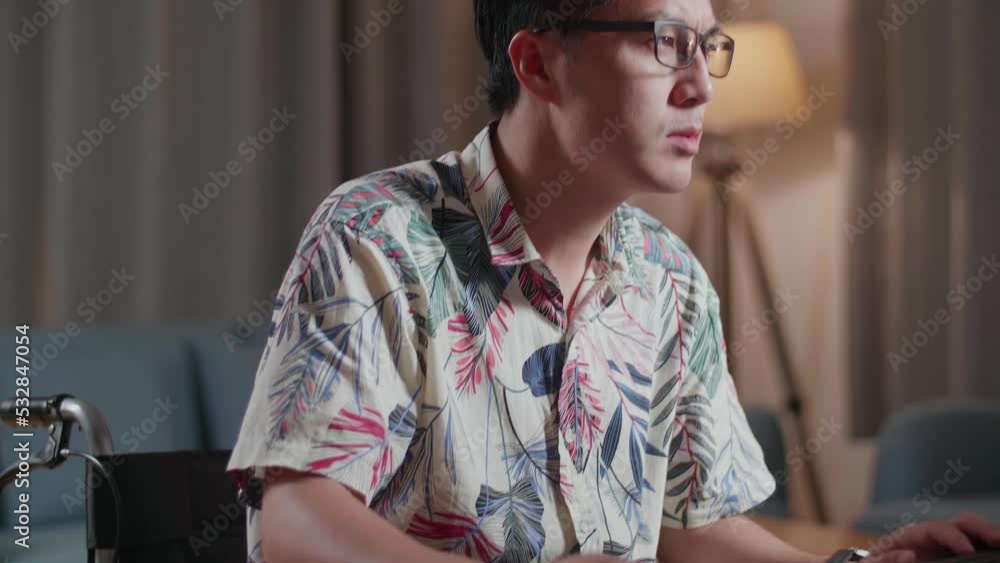 Close Up Of Asian Man In Wheelchair Stretching While Editing The Video By A Desktop Next To The Camera At Home
Close Up Of Asian Man In Wheelchair Stretching While Editing The Video By A Desktop Next To The Camera At Home