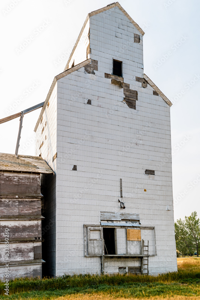 Old white wooden grain elevator by the tracks. Skiff, Alberta, Canada Old white wooden grain elevator by the tracks. Skiff, Alberta, Canada
