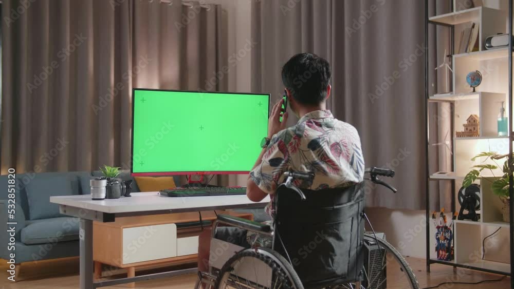 Back View Of Asian Man In Wheelchair Talking On Smartphone While Using Mock Up Green Screen Desktop Next To The Camera At Home
Back View Of Asian Man In Wheelchair Talking On Smartphone While Using Mock Up Green Screen Desktop Next To The Camera At Home