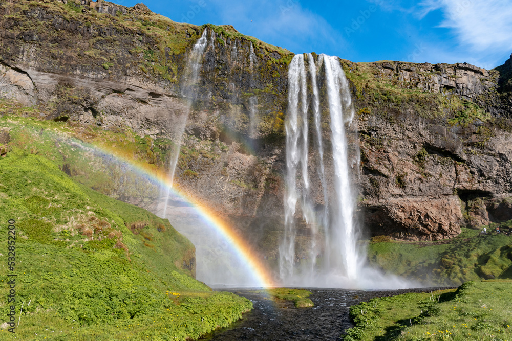 Obraz premium The waterfall Seljalandsfoss with a rainbow, famous landmark in southern Iceland