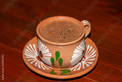 Traditional hot chocolate in a clay mug