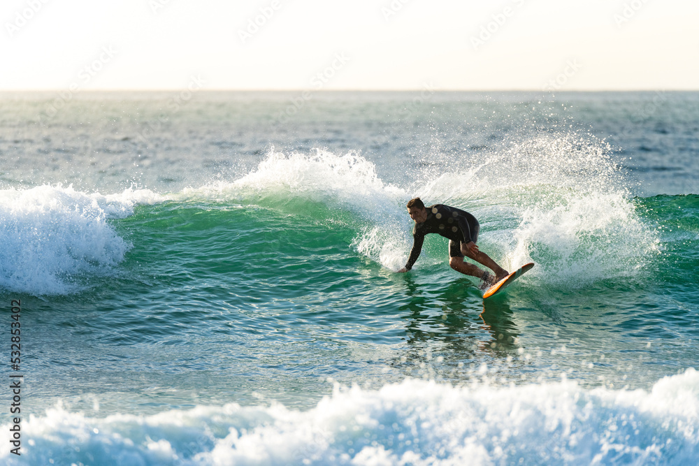 Surfer in action at sunset