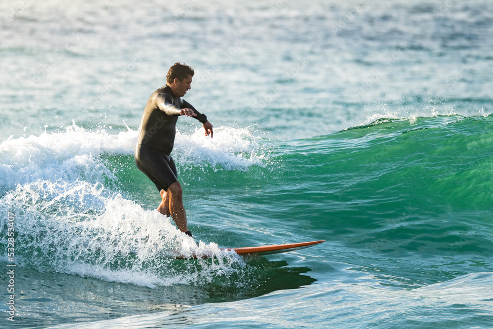 Surfer in action at sunset