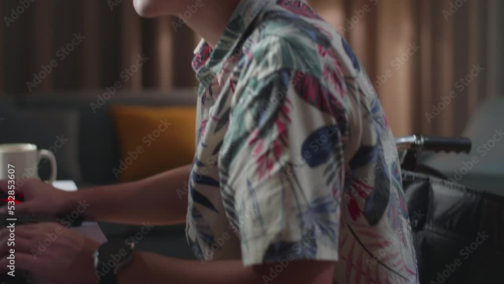 Close Up Side View Of Asian Man In Wheelchair In Photo Editing App, Software On His Personal Computer. Photo Editor Retouching Photos
