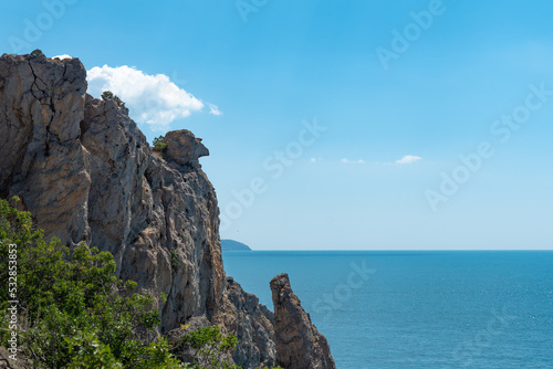 Canvas Print Rock reminiscent of the mythical character Mephistopheles, looking into the sky