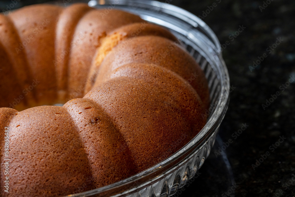 Foto de Just baked golden Rum Cake with syrup being brushed on for