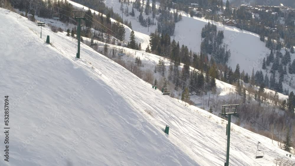 Aerial tracking along Chairlift on ski resort on sunny winter day in Utah Aerial tracking along Chairlift on ski resort on sunny winter day in Utah