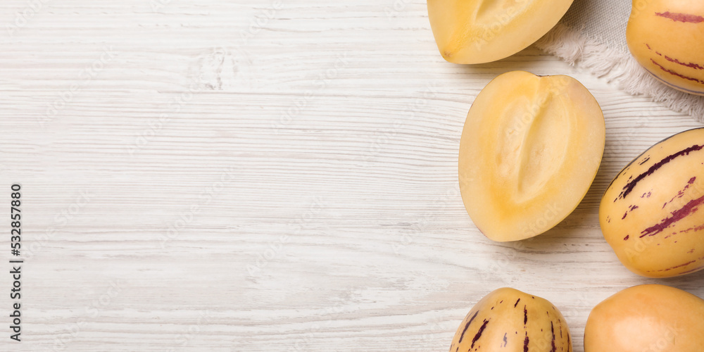 Fresh ripe pepino melons on white wooden table, flat lay with space for text. Banner design Fresh ripe pepino melons on white wooden table, flat lay with space for text. Banner design