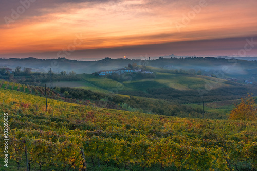 Amazing sunset over the Langhe  famous vineyard UNESCO area of Piedmont  Italy during autumn