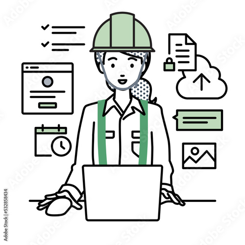 デスクで座ってPCでプロジェクトやタスクの管理の仕事をしている工事現場の女性