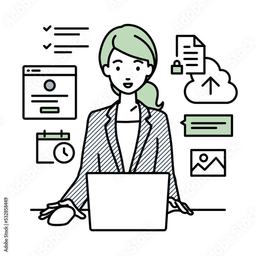 デスクで座ってPCでプロジェクトやタスクの管理の仕事をしているスーツの女性
