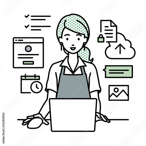 デスクで座ってPCでプロジェクトやタスクの管理の仕事をしているカフェ店員の女性