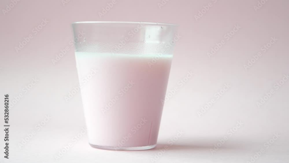 glass of strawberry milk on pink background glass of strawberry milk on pink background