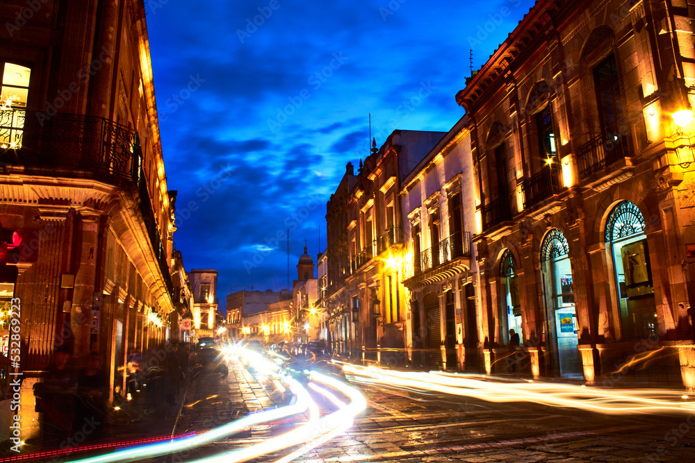 dark streets with golden lights and dusk sky blue color, colonial buildings in zacatecas at night 