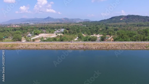 The road along the dam on a clear day photo