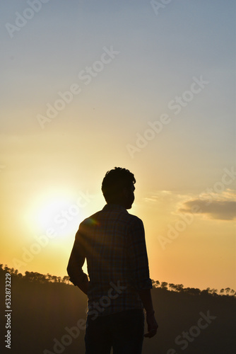 Man standing silhouette photo during sunset looking away