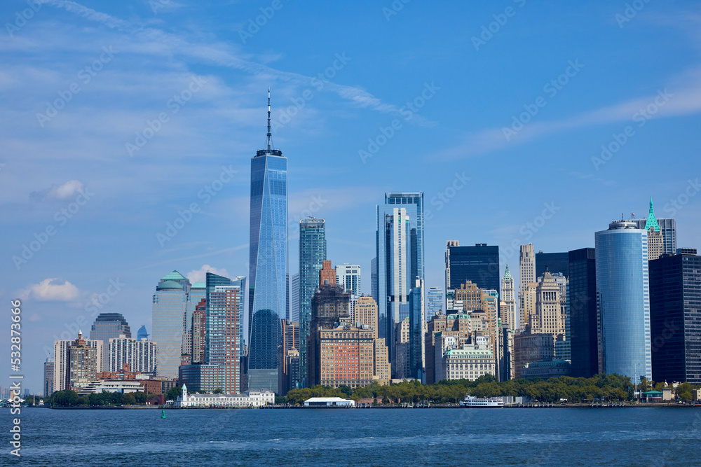 Fototapeta premium NYC skyline from a boat on a river seeing the giant city of Manhattan, NY USA on a sunny day