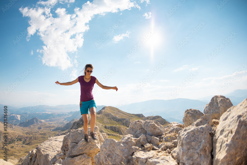 the girl is walking along the ridge of the mountain. the girl is walking along the ridge of the mountain.
