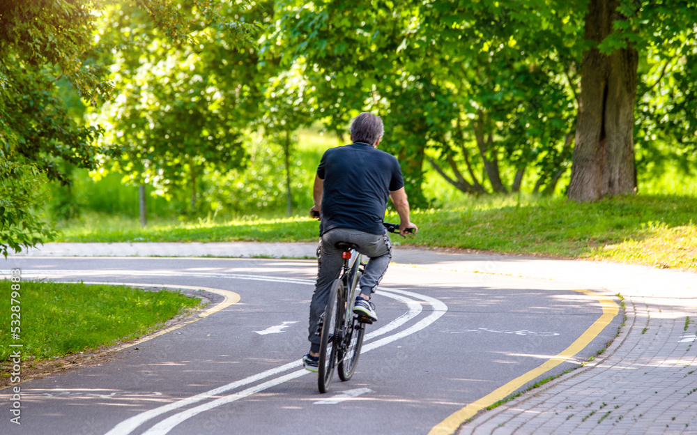 Cyclist ride on the bike path in the city Park
