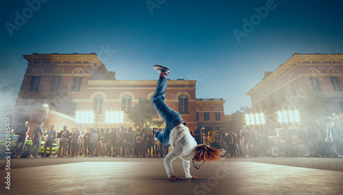 Street dancer girl dance breakdance on evening street