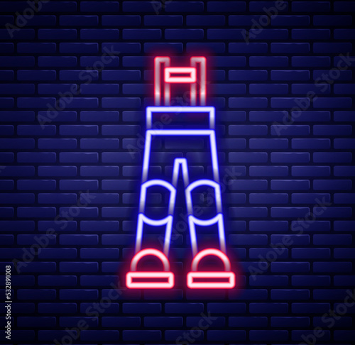 Glowing neon line Fisherman rubber pants icon isolated on brick wall background. Colorful outline concept. Vector