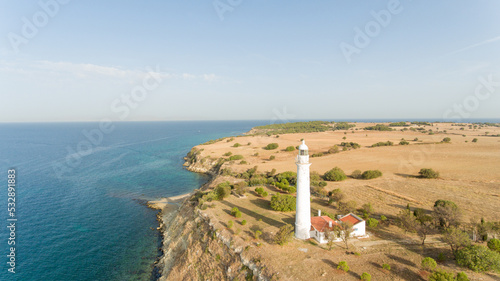 Aerial view of a lighthouse situated at the coast of Aegean Sea