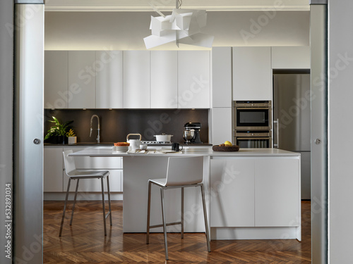 internal view of a modern kitchen with an island kitchen and wooden floor