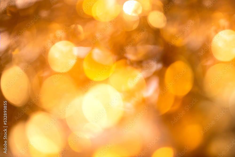 Abstract fective background with shine golden bokeh and sparling particles for wedding, holiday and party time.