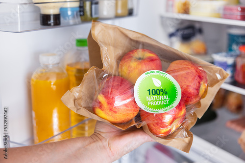 Obraz na plátně Woman holding package of ecologically grown apples, concept of eating healthy na