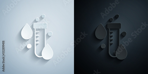 Paper cut Test tube with water drop icon isolated on grey and black background. Paper art style. Vector