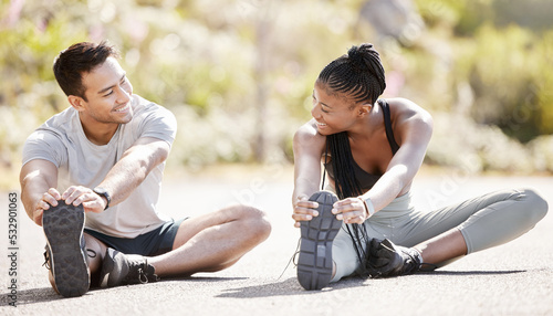 Sport, fitness and exercise with a sports man and woman training and stretching during an outdoor workout. Health, wellness and motivation with an athlete couple or personal trainer ready to start © Jade M/peopleimages.com