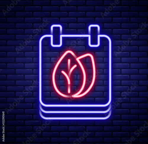 Glowing neon line Calendar with autumn leaves icon isolated on brick wall background. Colorful outline concept. Vector