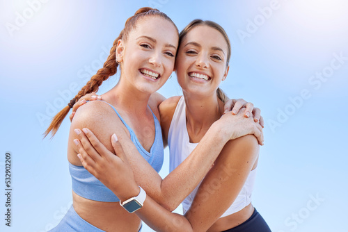 Sports, fitness friends or woman hug for support, motivation and teamwork on outdoor blue sky mock up sunshine lens flare. Happy young athlete people workout training together for a healthy lifestyle