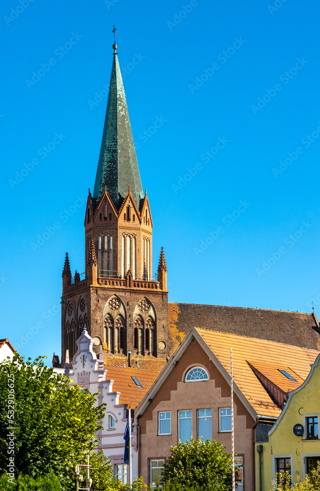 Obraz premium Historic Holy Mary gothic Kosciol Mariacki church in old town quarter of Trzebiatow in Poland