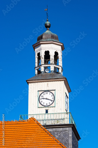 Clock tower of classicist Ratusz town hall palace at Rynek main market square in historic old town quarter of Trzebiatow in Poland