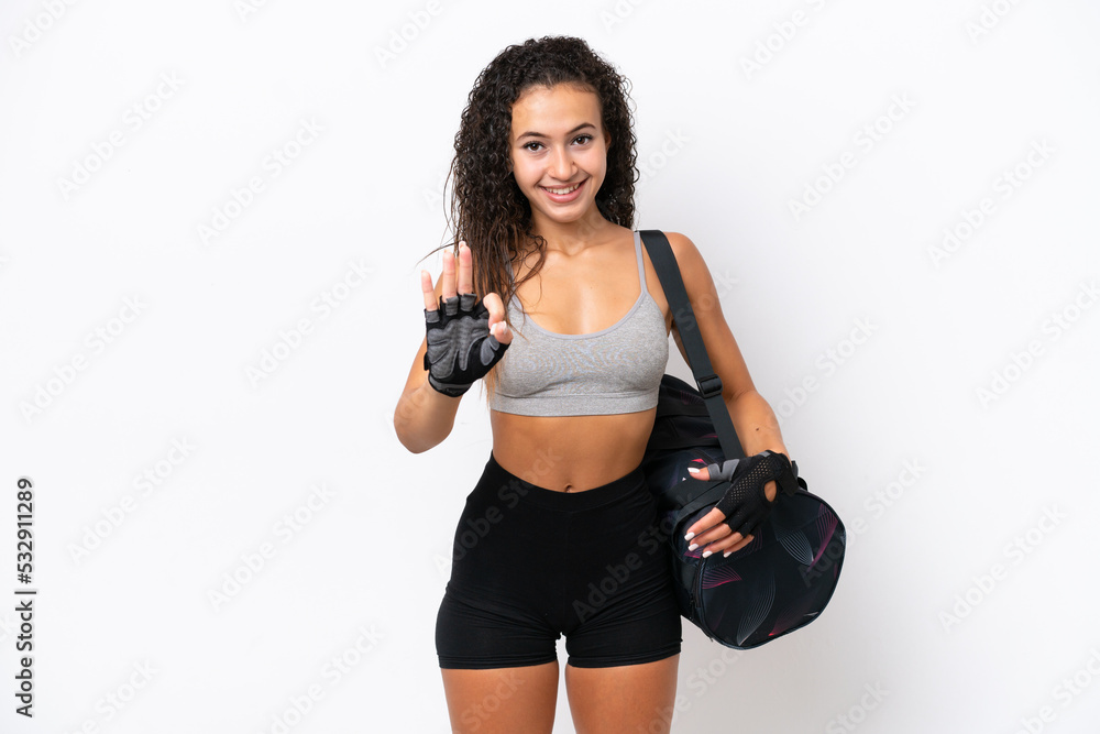 Young sport Arab woman with sport bag isolated on white background happy and counting three with fingers Young sport Arab woman with sport bag isolated on white background happy and counting three with fingers