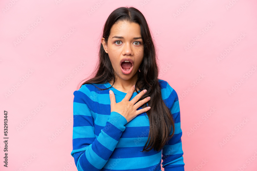 Young Colombian woman isolated on pink background surprised and shocked while looking right Young Colombian woman isolated on pink background surprised and shocked while looking right