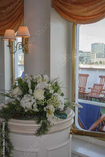 Fototapeta Naklejka Na Ścianę i Meble -  Elegant Belle Époque interior design furnishing bar lounge area onboard ocean liner cruiseship cruise ship with chairs, tables, bar counter and brass room dividers	