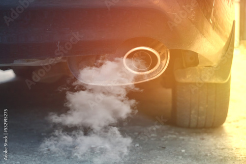 Smoke from the exhaust pipe of a car, air pollution by harmful emissions.
