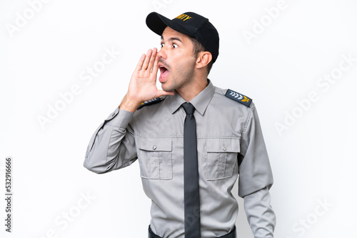 Young safeguard man over isolated white background shouting with mouth wide open to the lateral © luismolinero